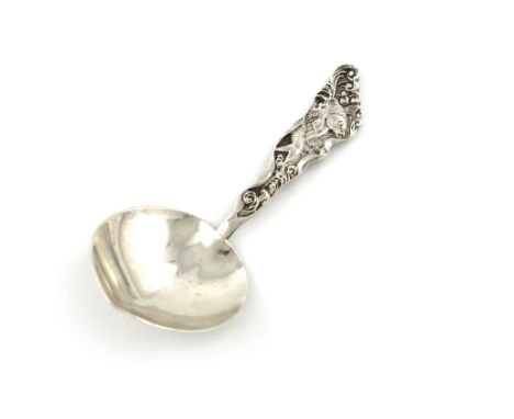 An American silver caddy spoon, by Gorham, Rhode Island, heart shaped bowl, the tapering handle cast with a fish within scrol