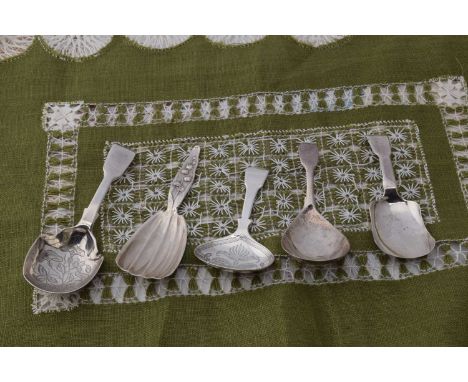 Five silver caddy spoons, including an Arts and Crafts Lily of the Valley handled Sterling marked example by Whiting &amp; Co