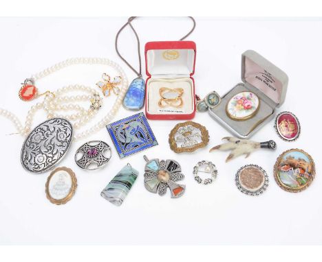 A collection of costume jewellery, including a miracle paste set Celtic cross, another Celtic brooch, various porcelain brooc