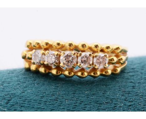 A continental yellow metal five stone diamond dress ring, the graduated brilliant cuts in four claw settings, ring size K, to