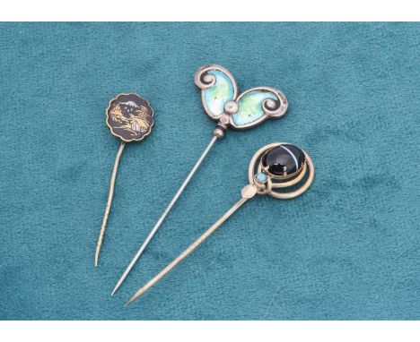 An early 20th Century silver and enamel stick pin, in the arts and crafts style, another stick pin with onyx and turquoise in