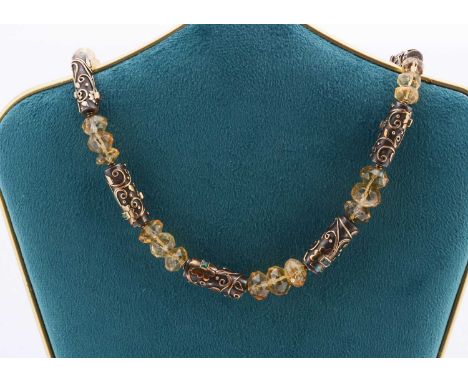 A contemporary silver and gem set necklace, the faceted Citrine beads alternately set between silver and yellow metal decorat