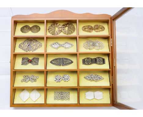 A large collection of costume and gilt metal jewellery, comprising five modern display cabinets with twelve compartments each