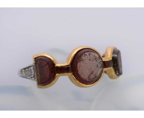 An art deco diamond and platinum and red paste set dress ring, the three panels of semi circular and circular design within a