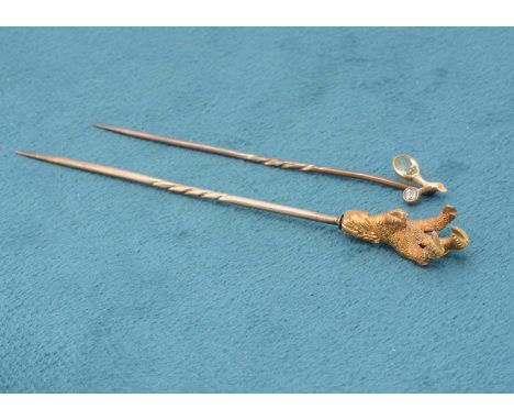 A 19th Century yellow metal claw set stick pin, modelled as an eagle's claw, with chased talons and scales and feather leg, 8