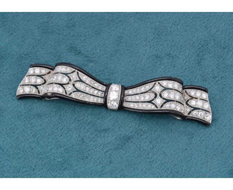 A French art deco diamond, enamel and platinum set bow brooch, the pierced architectural diamond set centre flanked by black 