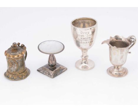 Four small collectable items, including a silver trophy goblet, 5.8cm high, dented, a jug, a covered tankard and a small tabl