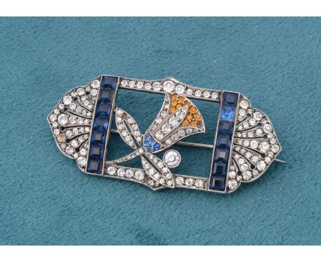 A continental white metal art deco paste brooch, of architectural fan design, centred with a budding flower with yellow, whit