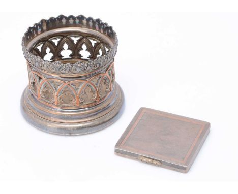 An Art Deco silver cigarette case with gold trim, together with a silver plated wine bottle coaster (2)