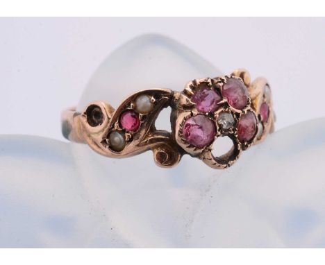 A Victorian garnet and diamond seed pearl set posey ring, with cluster and scroll set shoulders, two settings vacant, ring si