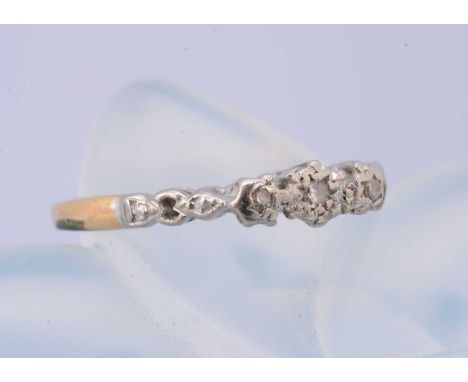 An 18ct gold and three stone platinum diamond dress ring, illusion set, ring size K, 1.8g