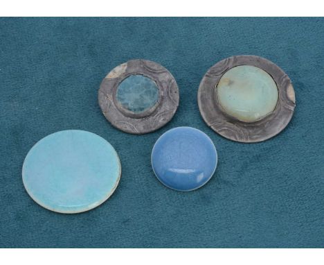 A blue Ruskin button, 2.5cm, a Ruskin roundel, 3.6cm, a pewter brooch with Ruskin centre and another, 3cm (4)