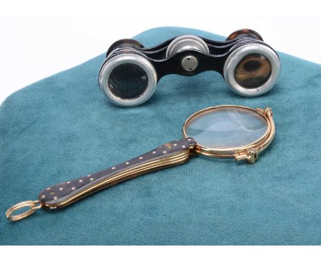 Two Pair of Opera Glasses, a pair of lorgnette, brass rim, tortoise shell style handle, chip to rim of one optic and a pair o