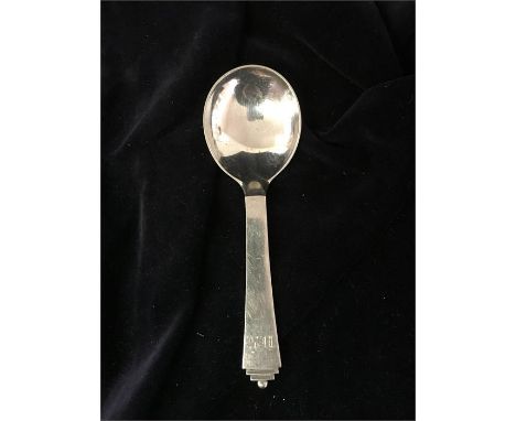 A silver caddy spoon by Georg Jensen in the pyramid pattern