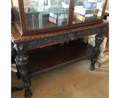 Oak side table with carved lags and shelf