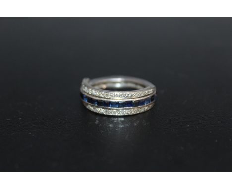 A DIAMOND AND TWO COLOUR SAPPHIRE 'FLIP OVER' RING, having two hinged half bands of diamonds and one side of blue sapphires a