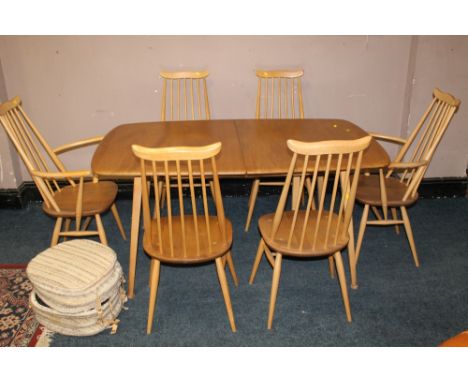 A BLOND ERCOL DRAWLEAF DINING TABLE WITH SIX STICKBACK CHAIRS, having two spare leaves