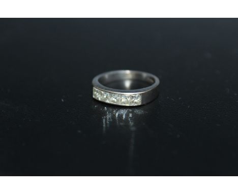 A HALLMARKED 18 CARAT GOLD CHANNEL SET PRINCESS CUT DIAMOND RING, set with five diamonds, approx weight 3.5g, ring size J