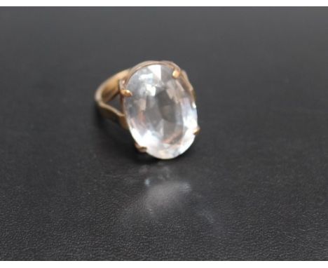 A 9CT GOLD DRESS RING, set with a large polished clear quartz style stone, approx 22 mm by 14 mm, approx weight 9.7g, ring si