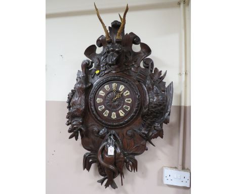 A VERY LARGE 19TH CENTURY BLACK FOREST HUNTING THEMED WALL CLOCK, the heavily carved case displaying hare, pheasant and fish,