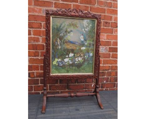 A 19TH CENTURY CARVED OAK FIRESCREEN WITH INSET WATERCOLOUR, carved with trailing vine leaves and grapes, raised on turned su