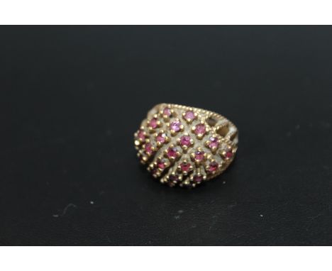 A 9CT RAISED GALLERY RUBY RING, set with 23 rubies approx weight 7.1g, ring size O