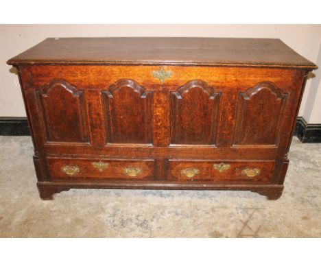 AN 18TH CENTURY OAK MULE CHEST, the hinged lid above a fielded four panel front, two drawers below, raised on bracket feet, W