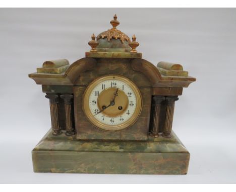 A GREEN VARIEGATED ONYX CASED MANTLE CLOCK OF ARCHITECTURAL FORM, having various gilded brass finials and side pillars, the e