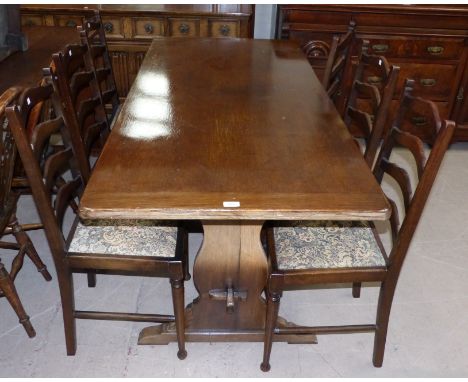A Jacobean style oak dining suite comprising refectory table, 6 ladder back chairs, and carved sideboard of 4 drawers and 2 d