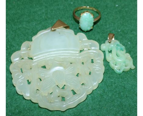 A lady's 9 carat hallmarked gold dress ring set oval jade coloured carved stone; a large pale jade coloured carved and pierce