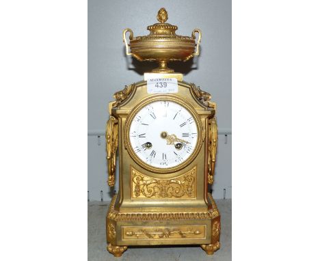 A classical Louis XVI style ornate ormolu mantel clock with vase finial and acanthus decoration, white enamel dial and French