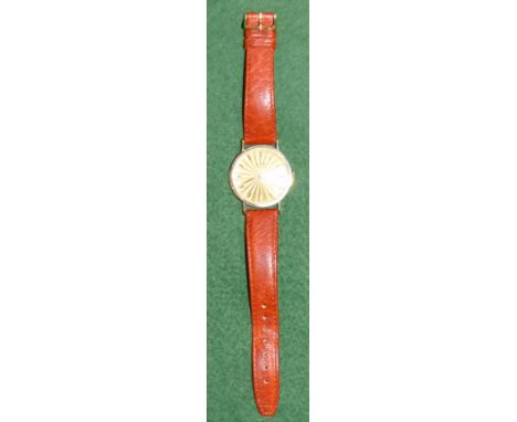A gent's Gruen wristwatch, stamped '14K', with engine turned dial and leather strap