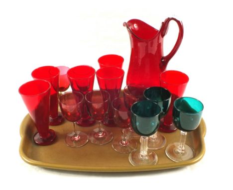 A ruby glass water set plus cranberry and green wine glasses