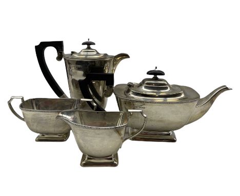 Silver 4 piece tea set of bead edge oblong design, the teapot and hot water jug with ebonised handles and lifts Sheffield 193