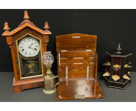 An early 20th century oak stationery box, 20.5cm high; a 19th century American mantel clock, 45cm high; a musical cigarette d