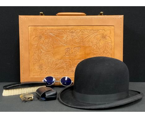 A tooled leather effect briefcase, 44cm wide; a bowler hat with ebony brush; a pair of blue tinted sunglasses; a pair of fold