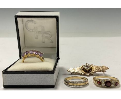 A 9ct gold bar brooch, set with seed pearl and ruby, 4.5cm safety chain, Birmingham 1904, 2.9g; a 9ct gold ring, se with five