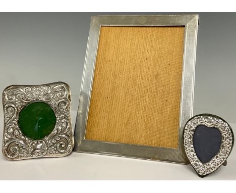 A George V silver easel photograph frame, engine turned, glazed, 23.5cm x 18.5cm, Birmingham 1928; a Victorian silver photogr