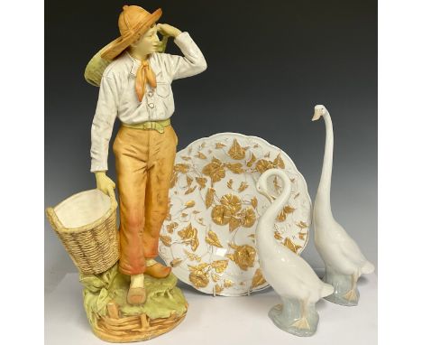 A Meissen porcelain shaped circular dish, moulded in relief with flowers and foliage, picked out in gilt, the base impressed 