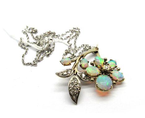 An Opal and Diamond Set Pendant, of flowerhead and leaf spray design, claw set with graduated oval cabochon opals and millegr