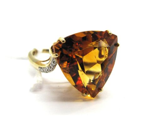 A Modern 9ct Gold "Mandarin" Citrine and Diamond Set Dress Ring, trillion cut to the centre, high between diamond set shoulde