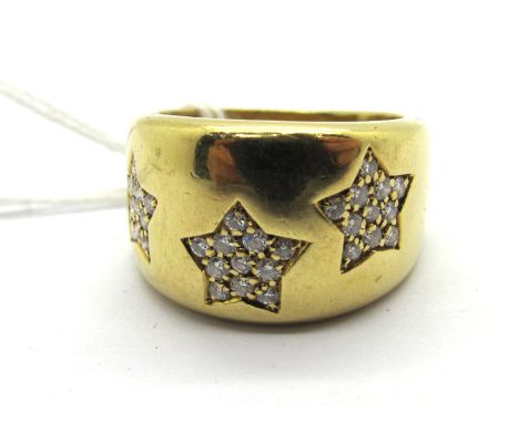 An 18ct Gold Wide Diamond Set Dress Ring, of tapering design, with three diamond set stars. 