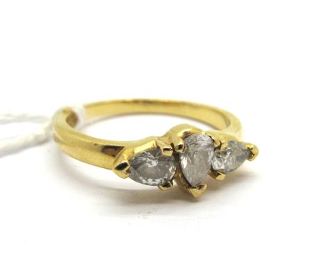 A Modern 18ct Gold Pear Shape Three Stone Diamond Ring, claw set, stamped "0 59".