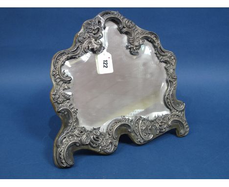A Decorative Hallmarked Silver Mounted Freestanding Mirror, William Comyns, London 1897, of shaped design detailed with flowe