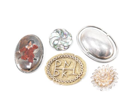 A group of silver brooch pins. This lot to include; a filigree flower, abalone panelled brooch, enamel portrait brooch, an ov