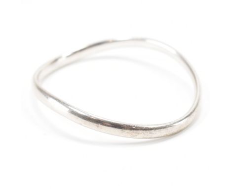 A vintage Georg Jensen Danish silver bangle. The bangle of organic asymmetric form. Marked Georg Jensen 925 S, with London im