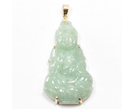 A gold and jade Buddha pendant. The carved jade Buddha depicted seated on a lotus flower in a gold mount and bale. Bale marke