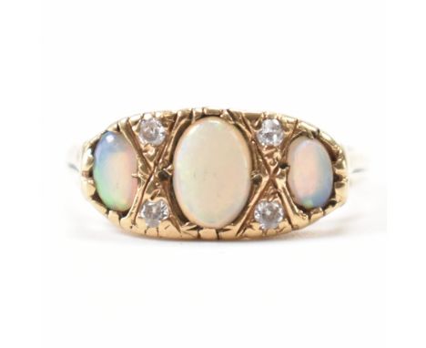 A vintage 9ct gold &amp; opal ring. The ring having three opal cabochons spaced by accent paste white stones. Marked 9ct gold