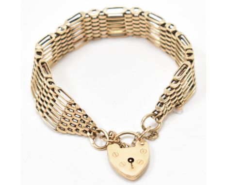 A hallmarked 9ct gold bar gate bracelet having a heart padlock link. Assay marked for London. Date letter R for 1991. Stamped