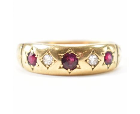 An gold diamond and ruby ring. The ring being set with three round cut rubies and two round cut diamonds. Marked 18ct gold. D